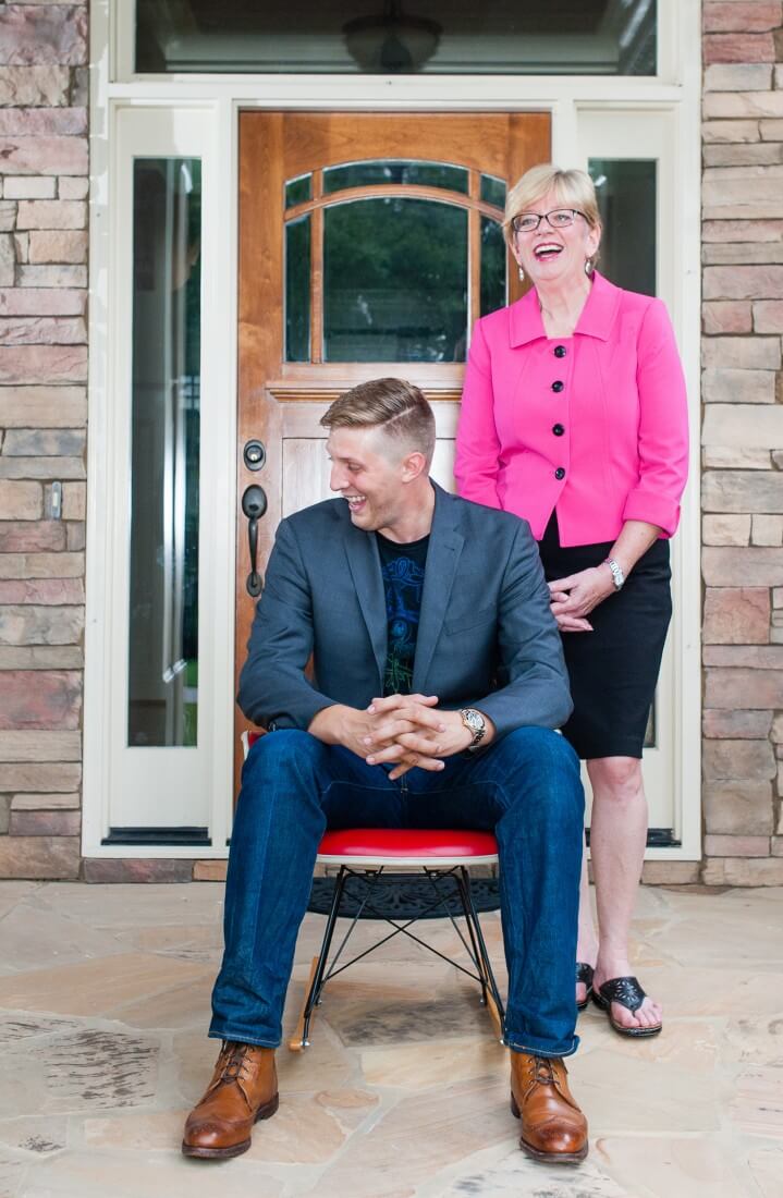 man sitting on chair and woman with smile 